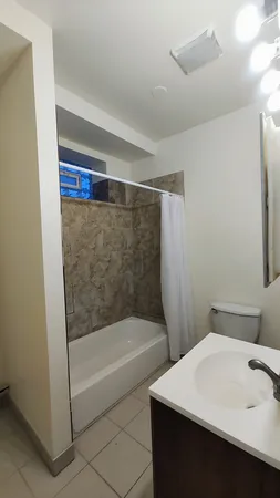 a bathroom with a bathtub and a shower