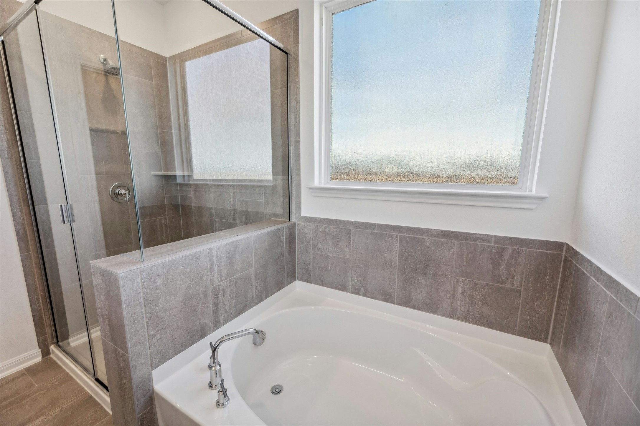 2001 Wynn Road Hutto, TX 78634 - Photo 17 of 39 Indulge in this bathroom featuring a large soaking tub and a spacious, tiled walk-in shower.
