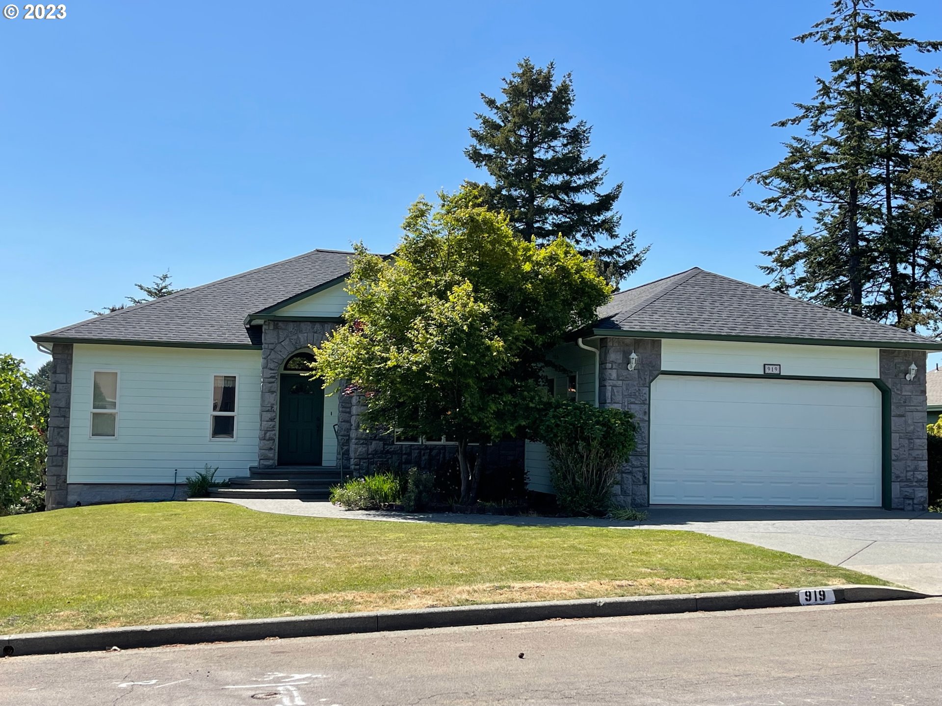 919 3rd Street Brookings, OR 97415 - Photo 1 of 36 a front view of a house with a yard and garage