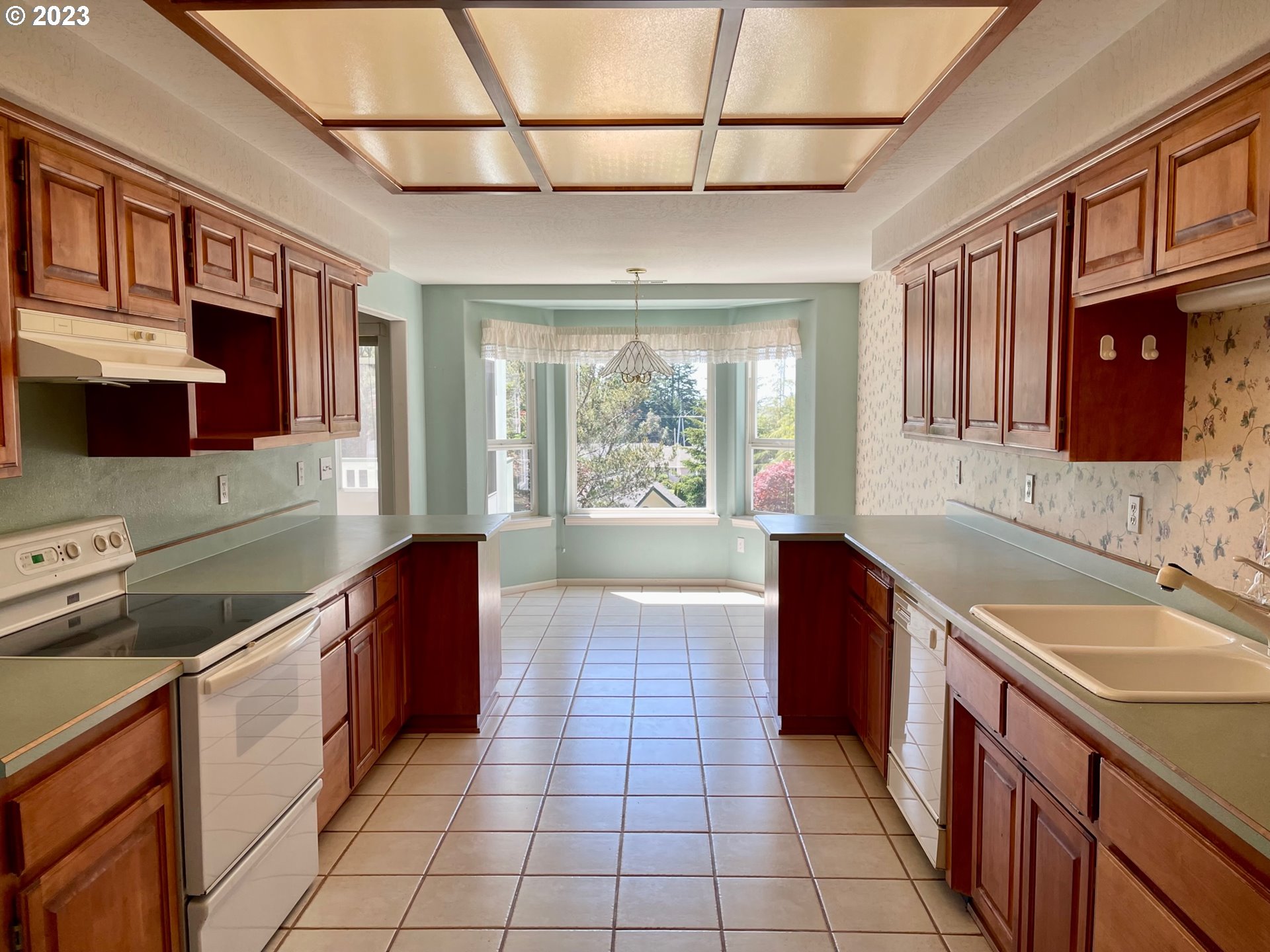 919 3rd Street Brookings, OR 97415 - Photo 16 of 36 a kitchen with stainless steel appliances granite countertop a sink stove and cabinets