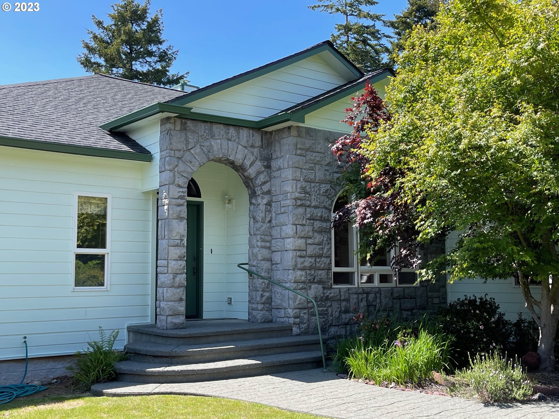 919 3rd Street Brookings, OR 97415 - Photo 2 of 36 a front view of a house with a garden