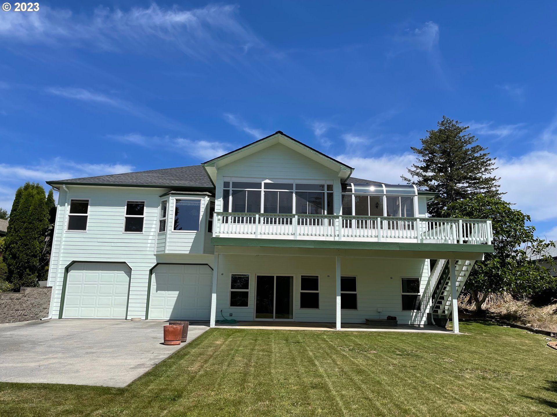 919 3rd Street Brookings, OR 97415 - Photo 3 of 36 a front view of a house with a yard