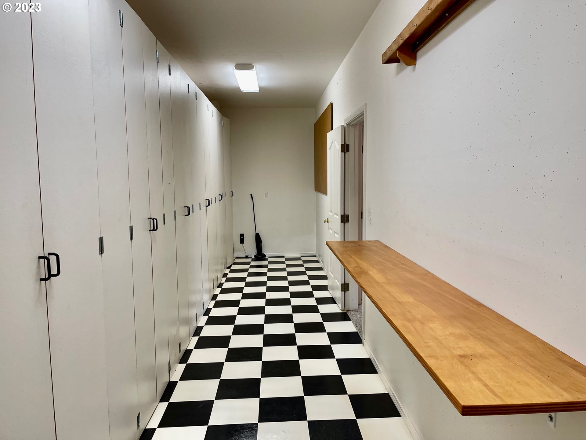 919 3rd Street Brookings, OR 97415 - Photo 34 of 36 a hallway with a black white checkered floor and a black white checkered floor