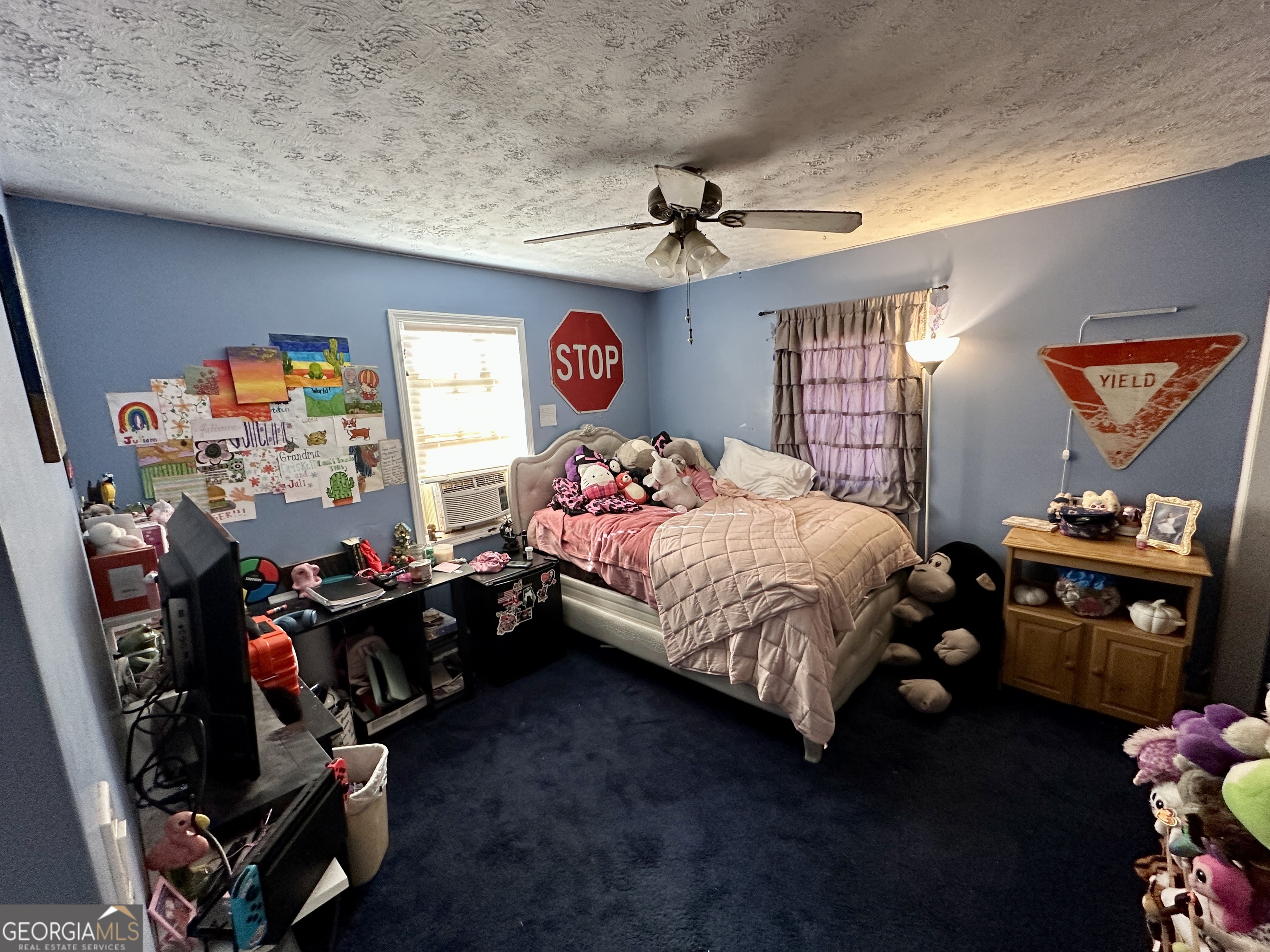 171 Hoyt Road Milner, GA 30257 - Photo 24 of 26 a bedroom with bed and a chandelier
