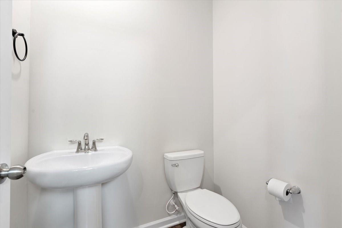 7730 Sea Turtle Way Lancaster, SC 29720 - Photo 11 of 24 a bathroom with a toilet sink and mirror