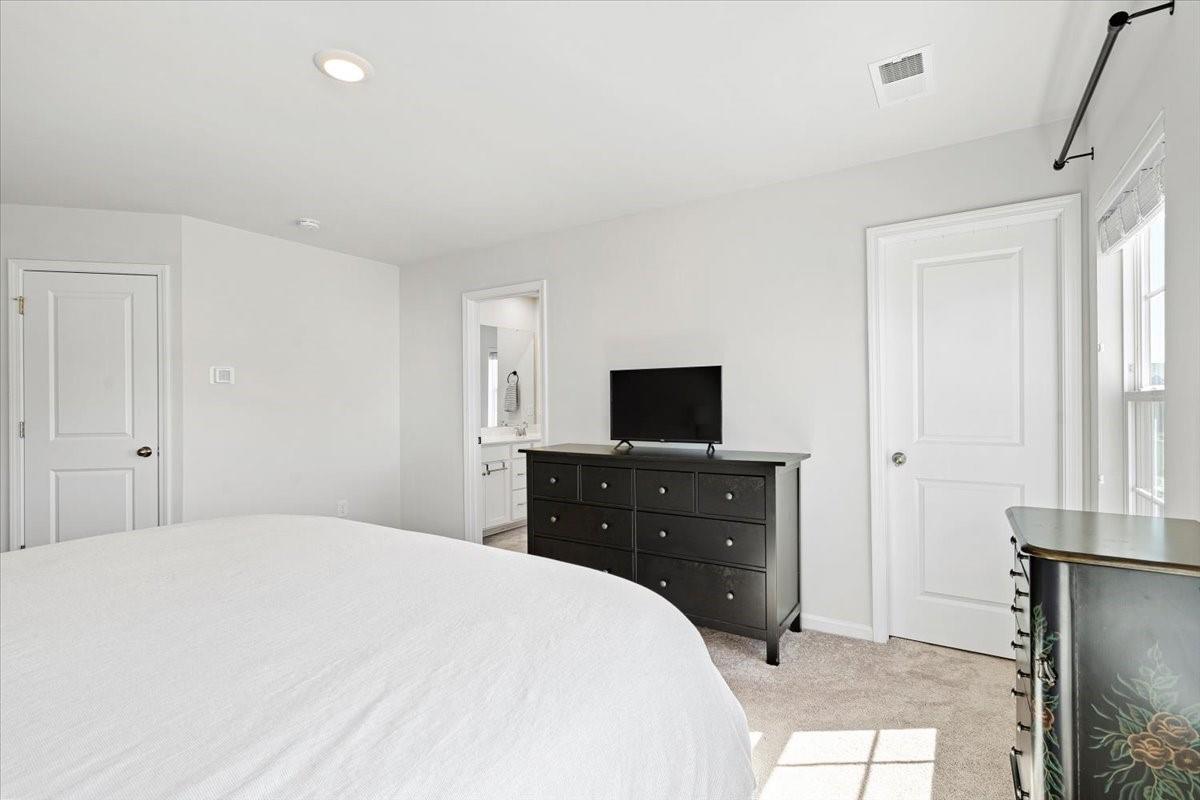 7730 Sea Turtle Way Lancaster, SC 29720 - Photo 17 of 24 a bedroom with a bed and a flat screen tv