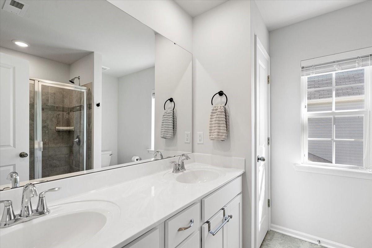 7730 Sea Turtle Way Lancaster, SC 29720 - Photo 18 of 24 a bathroom with double vanity sinks and a mirror