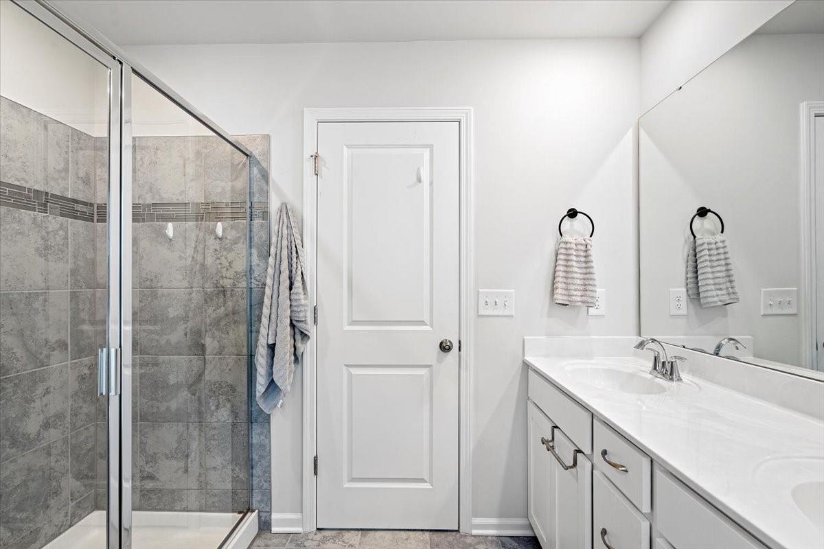 7730 Sea Turtle Way Lancaster, SC 29720 - Photo 19 of 24 a bathroom with a shower sink and mirror