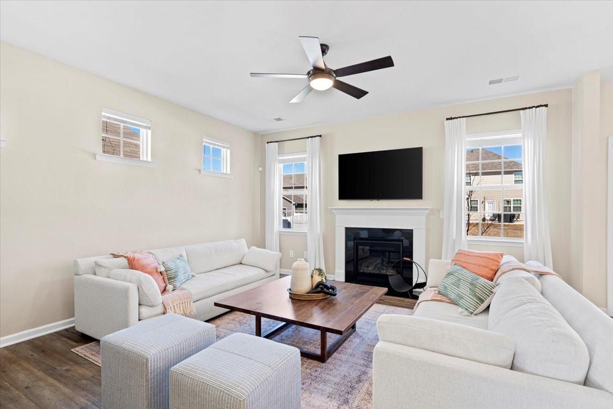 7730 Sea Turtle Way Lancaster, SC 29720 - Photo 3 of 24 a living room with furniture a fireplace and a flat screen tv