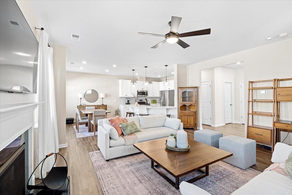 7730 Sea Turtle Way Lancaster, SC 29720 - Photo 4 of 24 a living room with furniture kitchen view and a fireplace