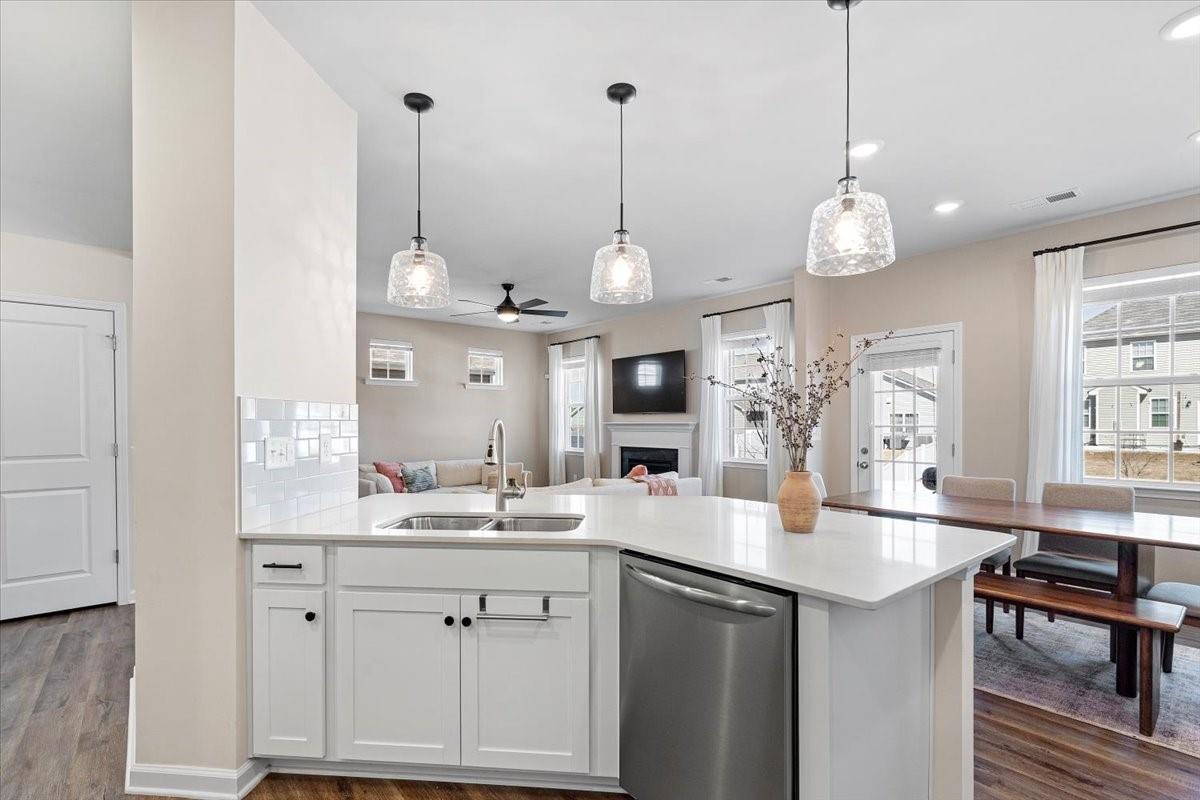 7730 Sea Turtle Way Lancaster, SC 29720 - Photo 5 of 24 a large kitchen with kitchen island a large island in the center and stainless steel appliances