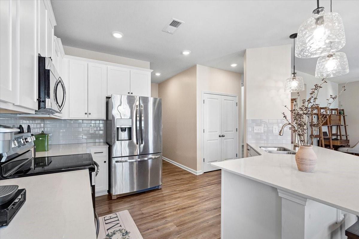 7730 Sea Turtle Way Lancaster, SC 29720 - Photo 9 of 24 a kitchen with kitchen island a sink stainless steel appliances and cabinets