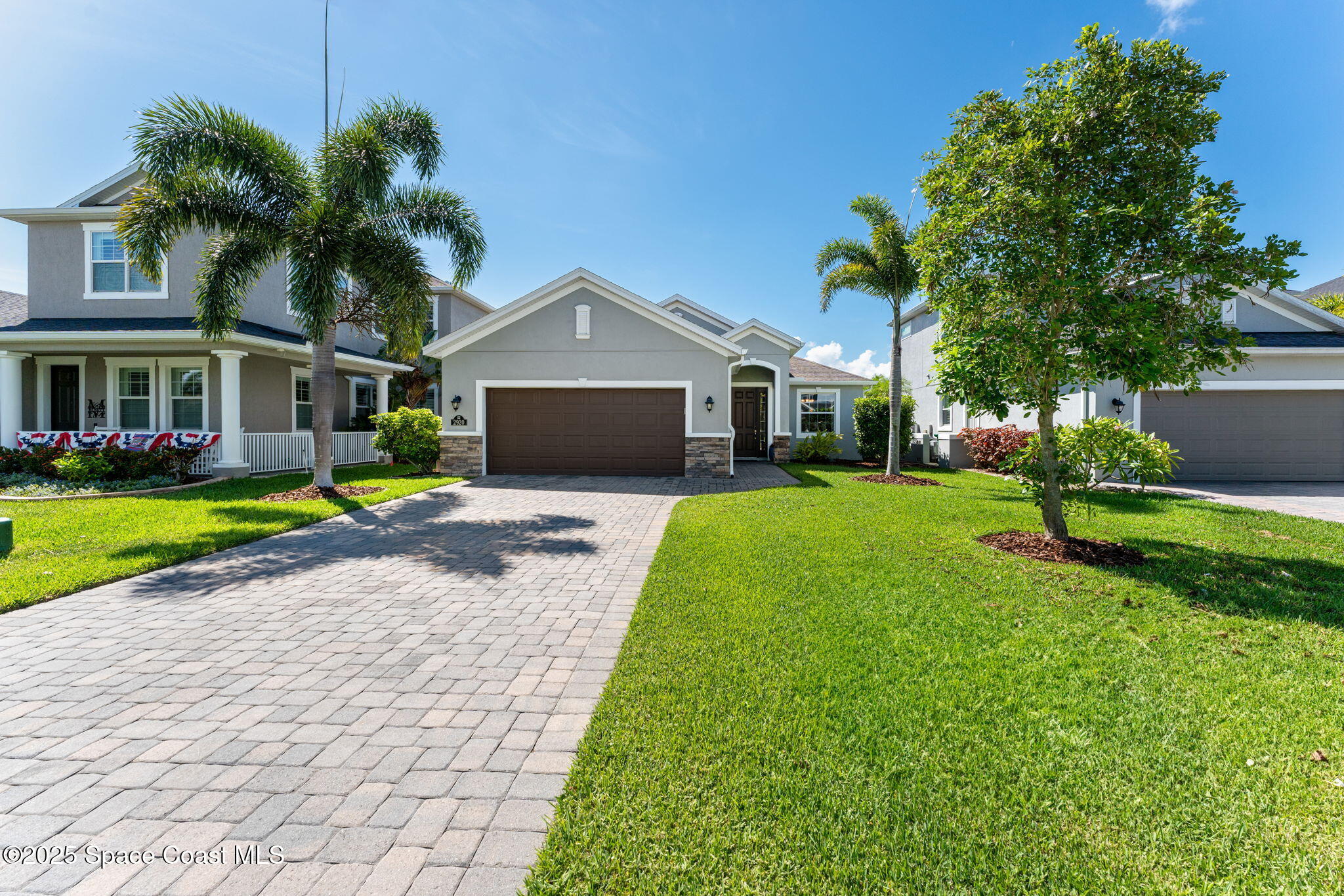 a front view of house with yard and green space