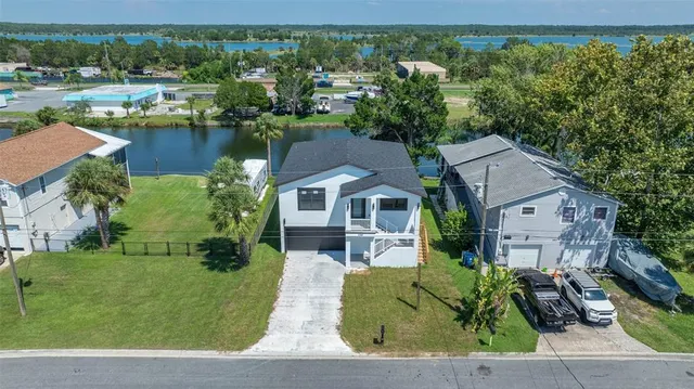 an aerial view of a house with garden space and lake view