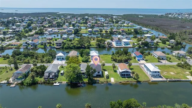 an aerial view of residential houses with outdoor space and lake view