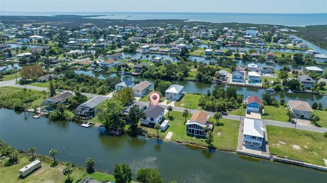 an aerial view of lake and residential houses with outdoor space