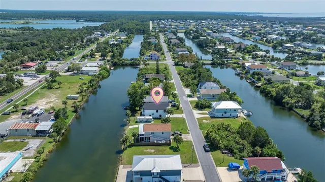 an aerial view of house with yard swimming pool and ocean view