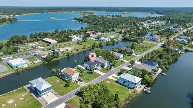 an aerial view of a house with a lake view