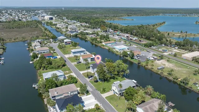 an aerial view of lake and residential houses with outdoor space