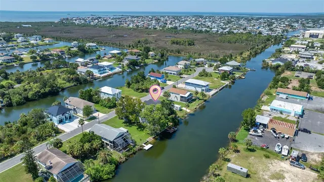 an aerial view of residential houses with outdoor space and lake view