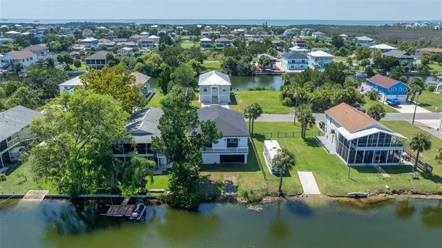 an aerial view of residential houses with lake view