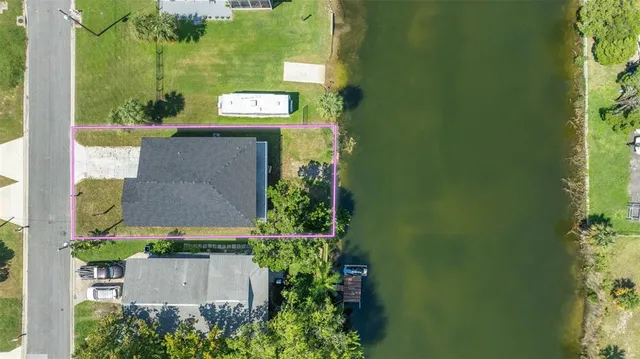 an aerial view of a house with a yard