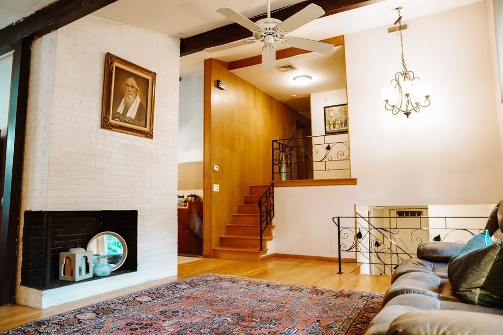 17 Brandeis Road Newton, MA 02459 - Photo 23 of 24 a living room with furniture and a fireplace