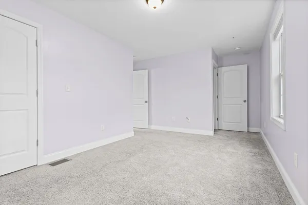 a view of an empty room with windows