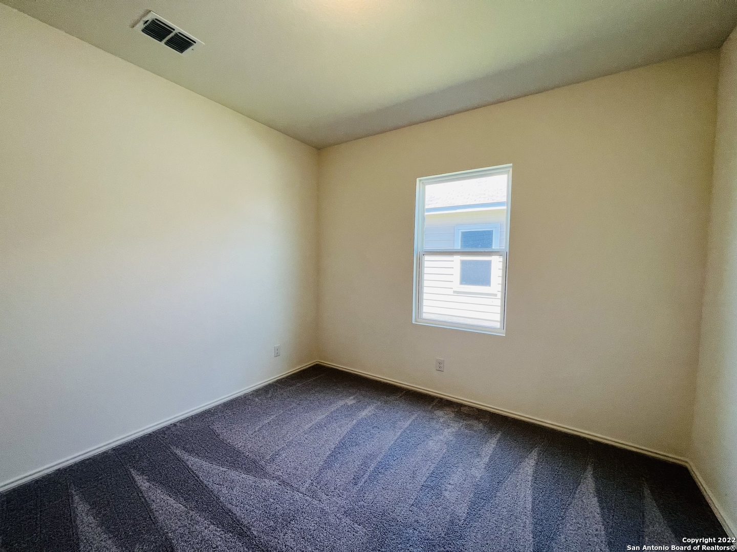 8907 Colony Meadow Converse, TX 78109 - Photo 11 of 31 a view of an empty room with wooden floor and a window