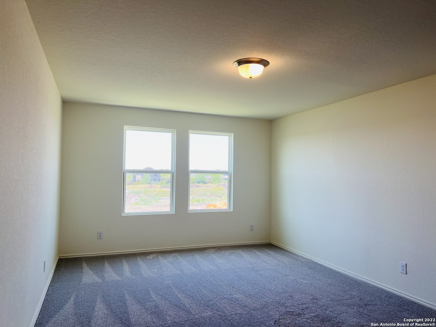 8907 Colony Meadow Converse, TX 78109 - Photo 17 of 31 an empty room with wooden floor and windows