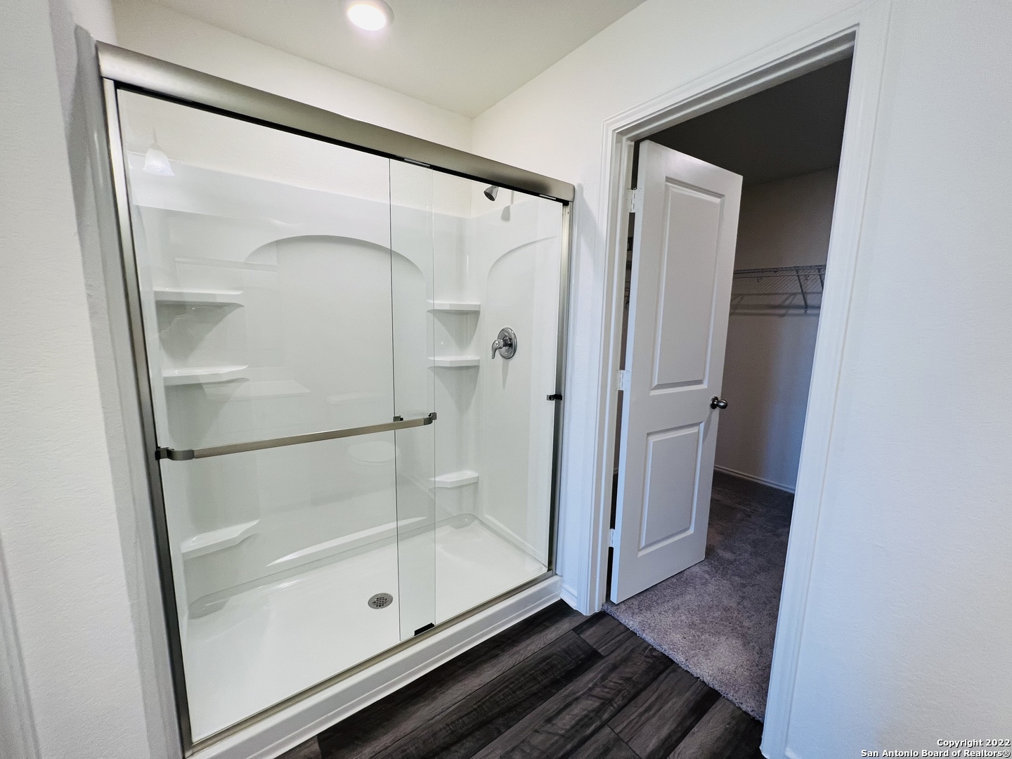 8907 Colony Meadow Converse, TX 78109 - Photo 22 of 31 a bathroom with a glass shower door and mirror