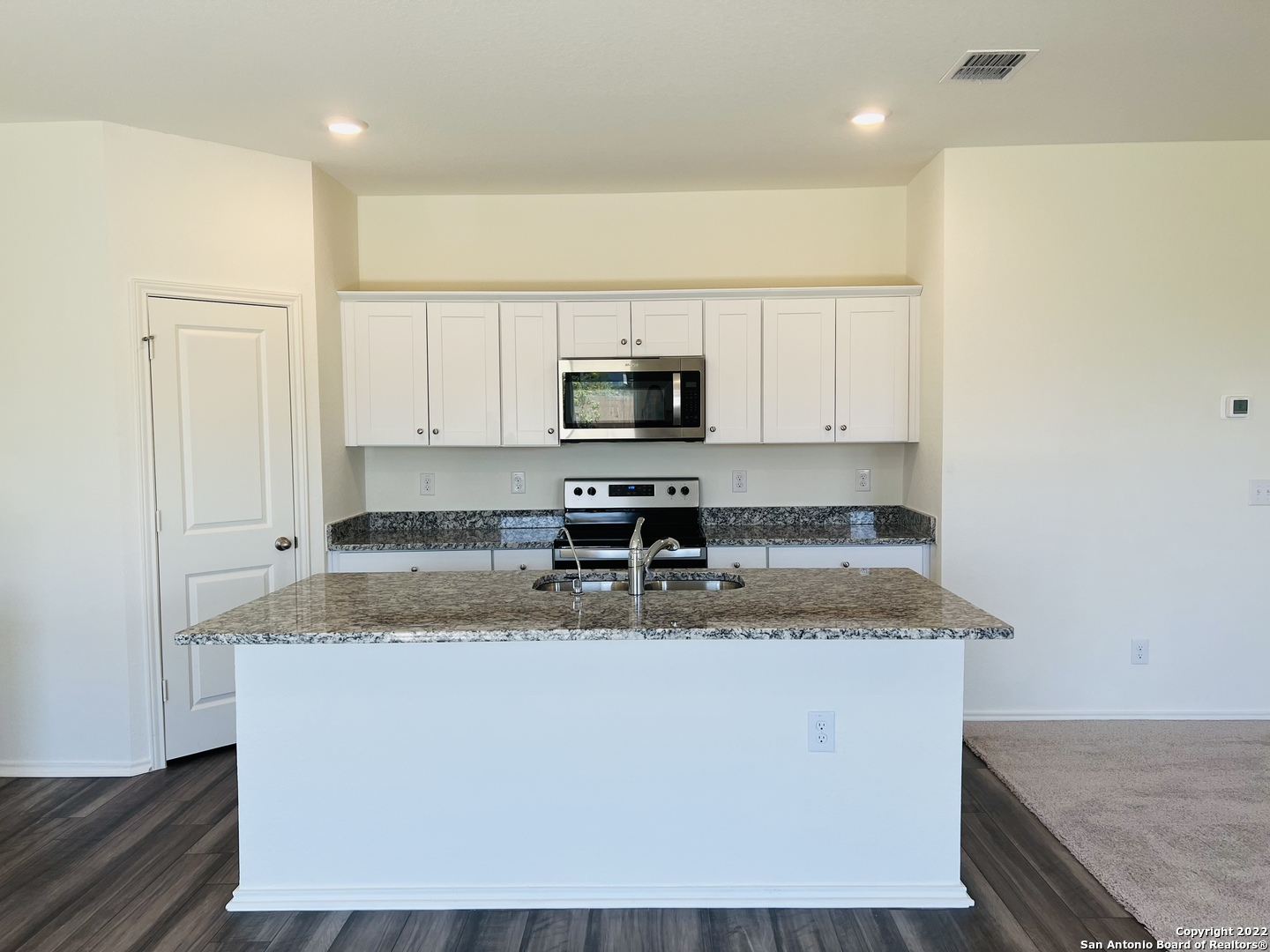 8907 Colony Meadow Converse, TX 78109 - Photo 3 of 31 a kitchen with stainless steel appliances granite countertop a sink a stove and a microwave