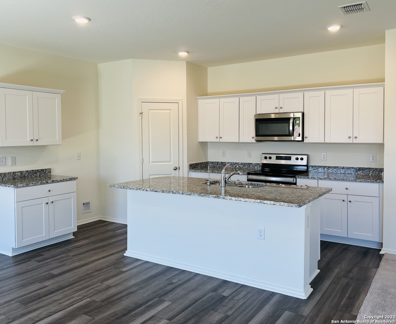 8907 Colony Meadow Converse, TX 78109 - Photo 5 of 31 a kitchen with kitchen island granite countertop a sink and white appliances