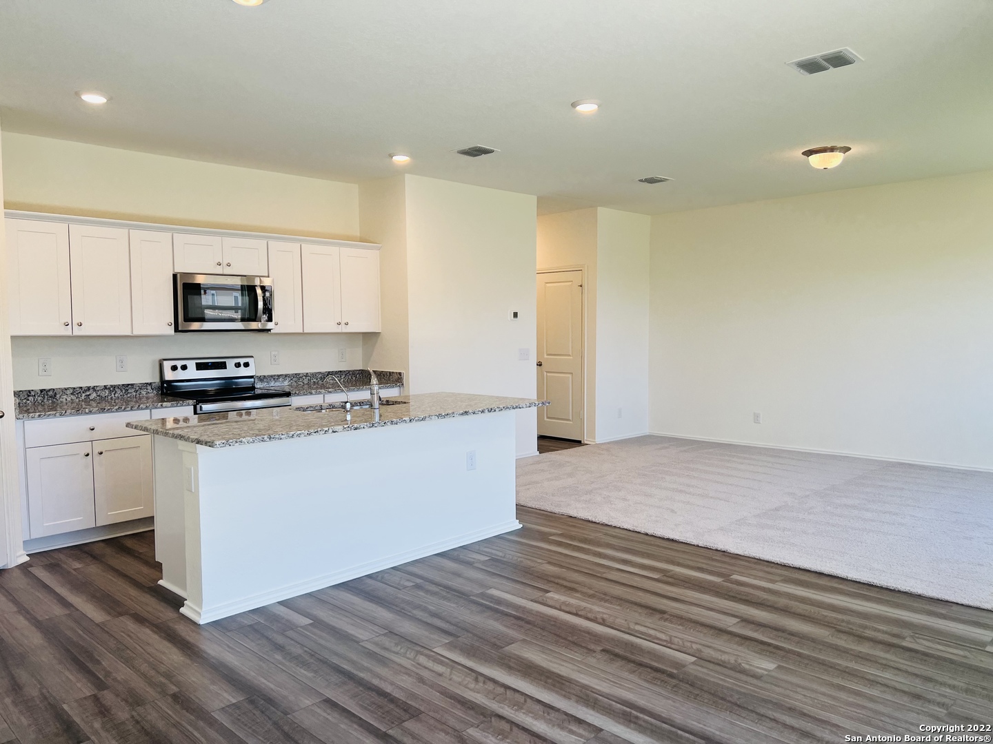 8907 Colony Meadow Converse, TX 78109 - Photo 7 of 31 a kitchen with a sink a microwave and cabinets
