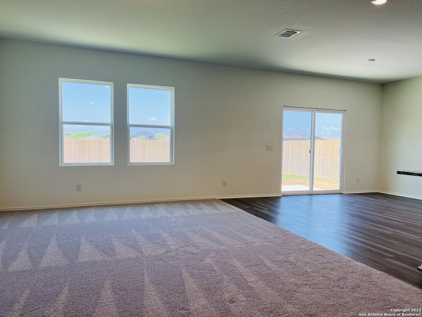 8907 Colony Meadow Converse, TX 78109 - Photo 8 of 31 an empty room with wooden floor and windows