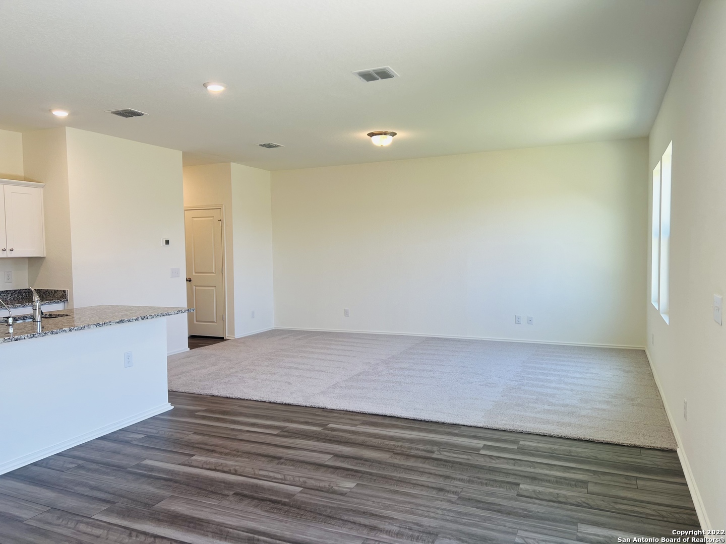 8907 Colony Meadow Converse, TX 78109 - Photo 9 of 31 a view of a large kitchen with wooden floor and a sink