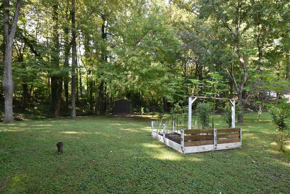 7701 Cresthill Court Raleigh, NC 27615 - Photo 28 of 29 Another view of the shed and gardening area. Backyard