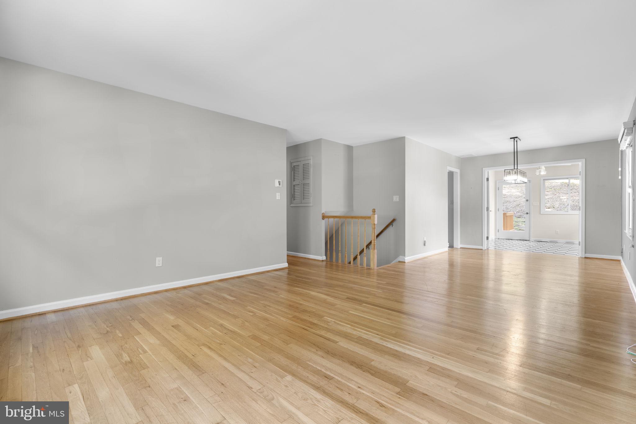 822 Loxford Terrace Silver Spring, MD 20901 - Photo 5 of 61 a view of an empty room with wooden floor and a window