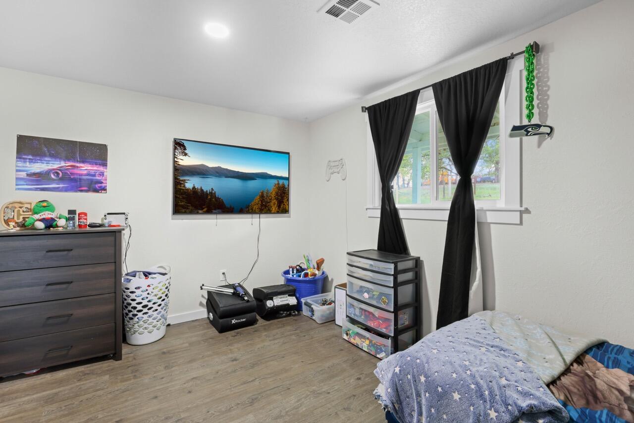 380 Greenleaf Drive Eagle Point, OR 97524 - Photo 24 of 31 a bedroom with furniture and a flat screen tv