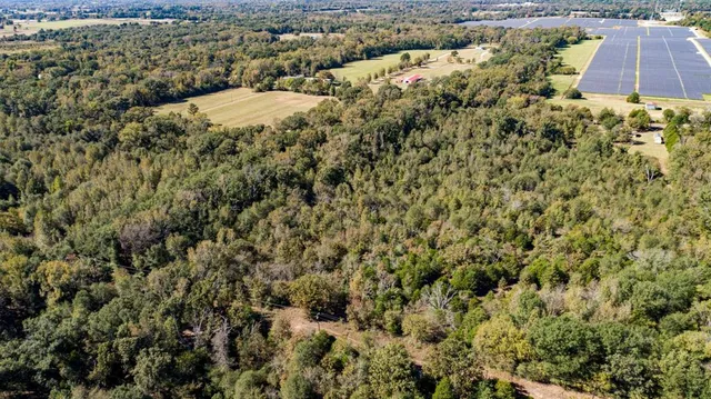 an aerial view of a residential houses with city view