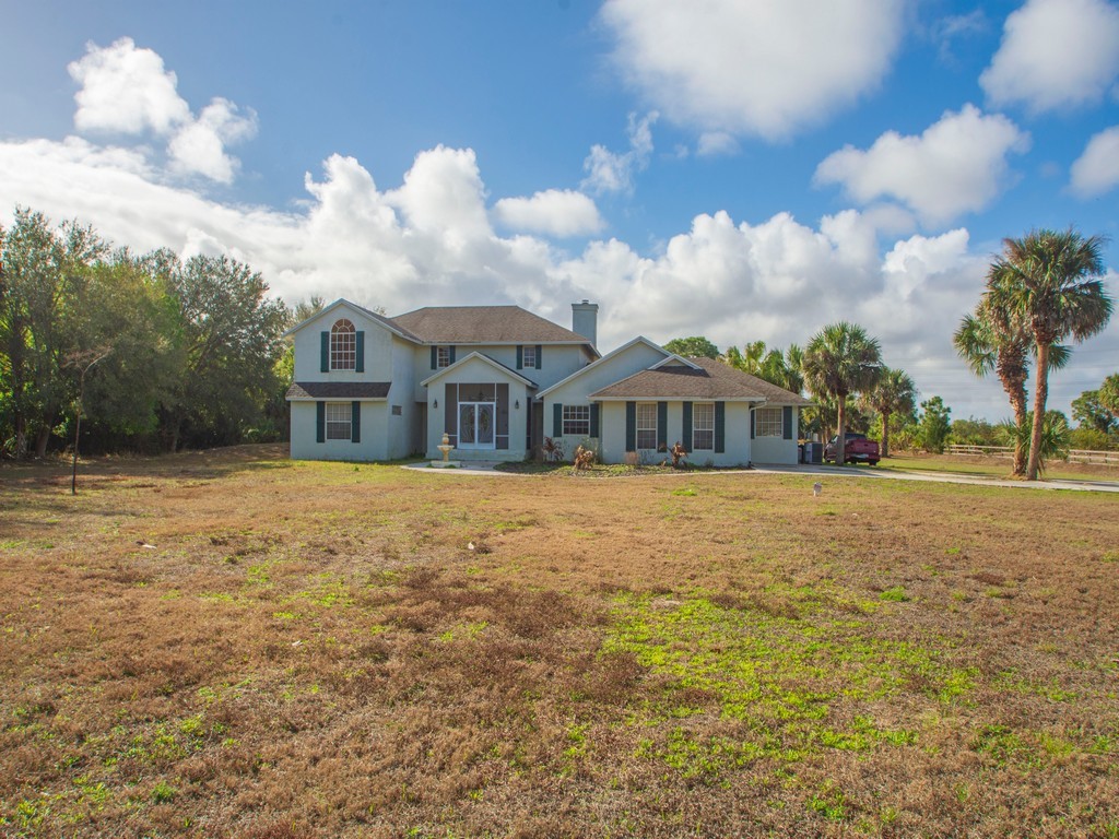 167 Deer Run Road Palm Bay, FL 32909 - Photo 4 of 35 a front view of a house with a yard