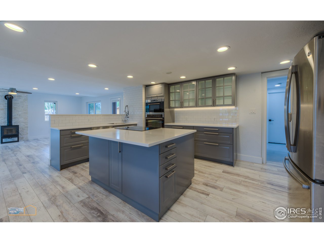 8155 Hygiene Road Longmont, CO 80503 - Photo 11 of 40 a kitchen with kitchen island a sink stainless steel appliances and cabinets