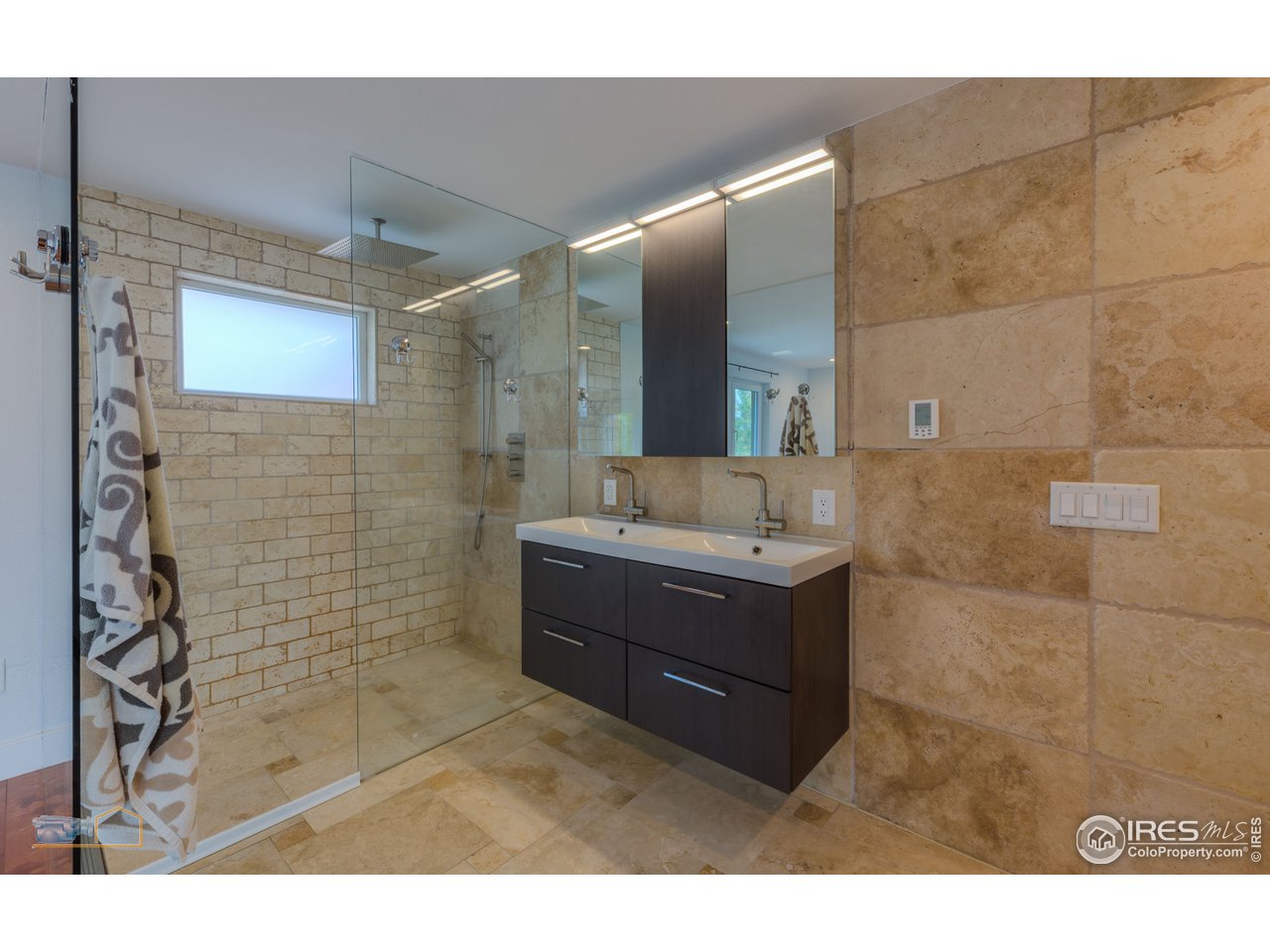8155 Hygiene Road Longmont, CO 80503 - Photo 16 of 40 a bathroom with a sink mirror and shower