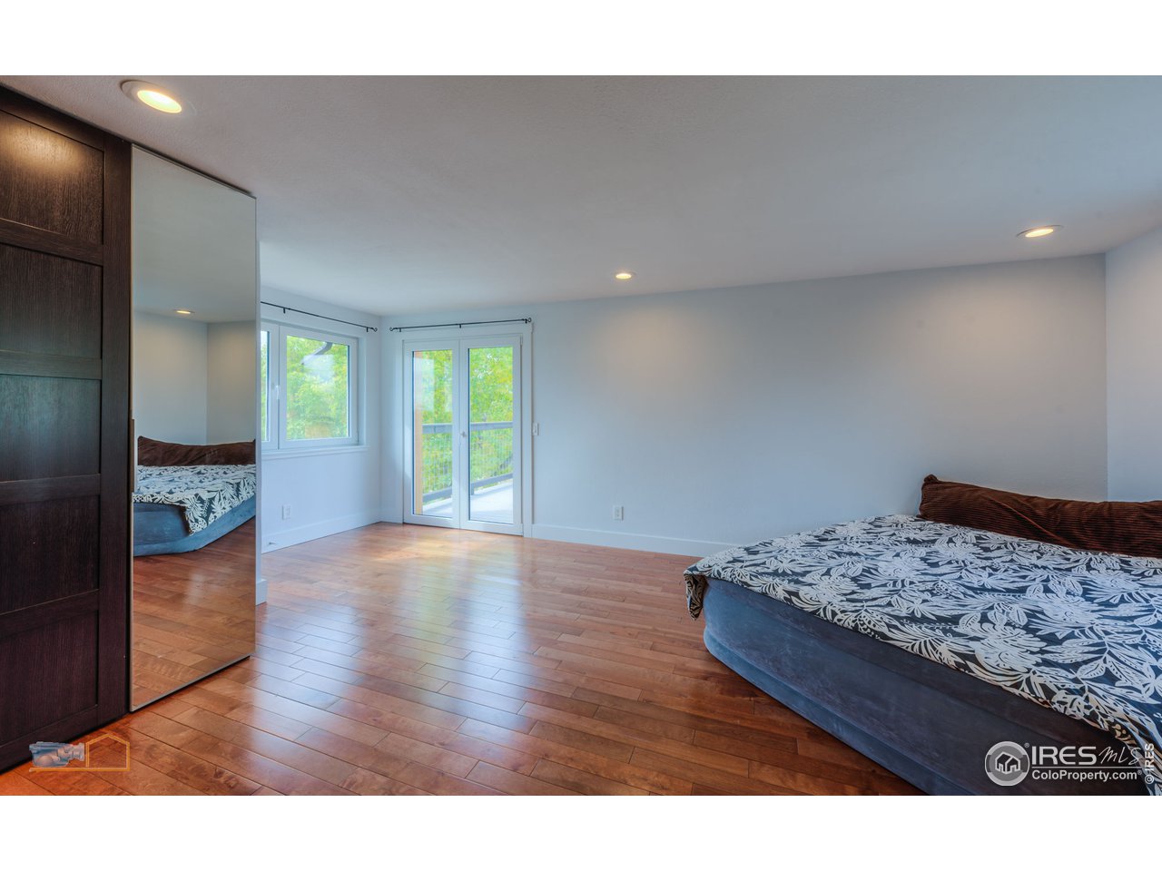 8155 Hygiene Road Longmont, CO 80503 - Photo 17 of 40 a view of a bedroom with wooden floor and bedroom