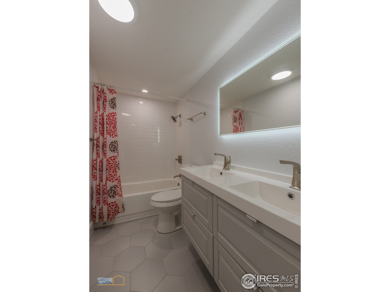8155 Hygiene Road Longmont, CO 80503 - Photo 20 of 40 a bathroom with a toilet sink and mirror