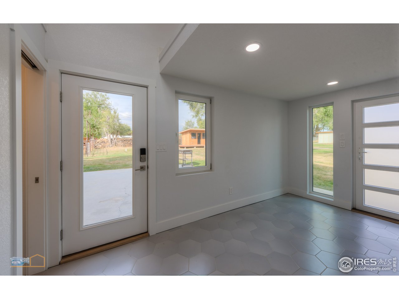 8155 Hygiene Road Longmont, CO 80503 - Photo 22 of 40 a view interior of a house with wooden floor and windows