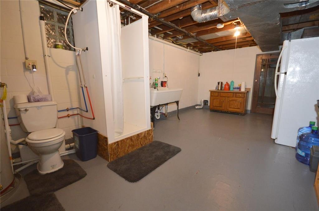 2610 Pulaski Road New Castle, PA 16105 - Photo 18 of 25 3rd bathroom in basement area has shower and toilet. Additional laundry hookup is also located in this space, which leads to an enormous storage area.