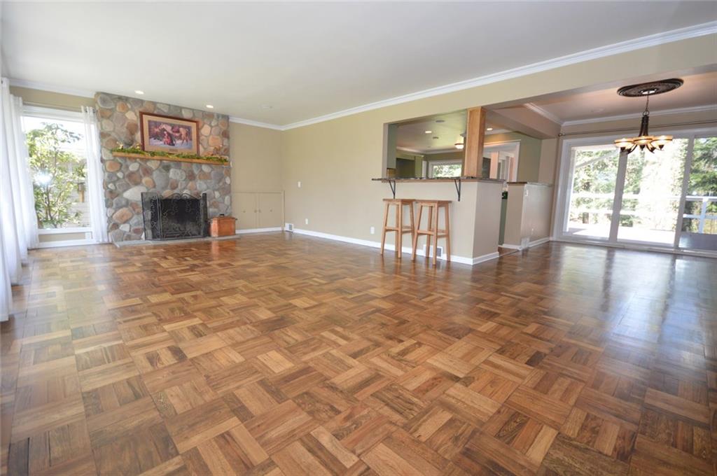 2610 Pulaski Road New Castle, PA 16105 - Photo 3 of 25 The open concept living room / dining room/ kitchen features gleaming refinished hardwood floors and a custom stone fireplace.