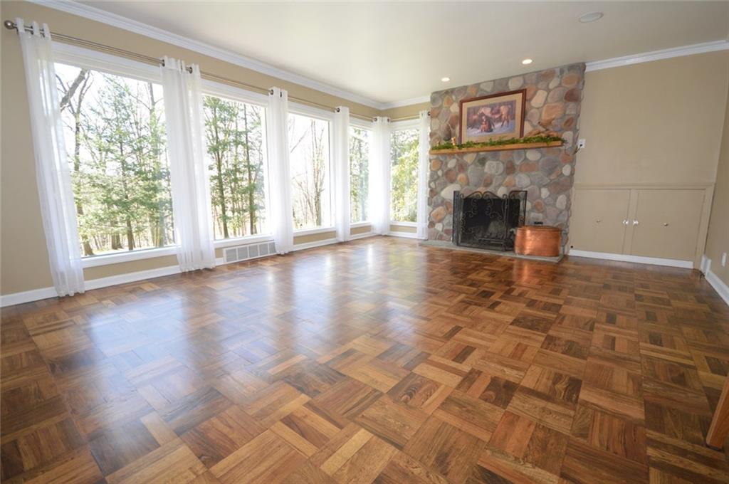 2610 Pulaski Road New Castle, PA 16105 - Photo 4 of 25 Enjoy light filled room and the view of the wooded lot through floor to ceiling window at the front of the home.