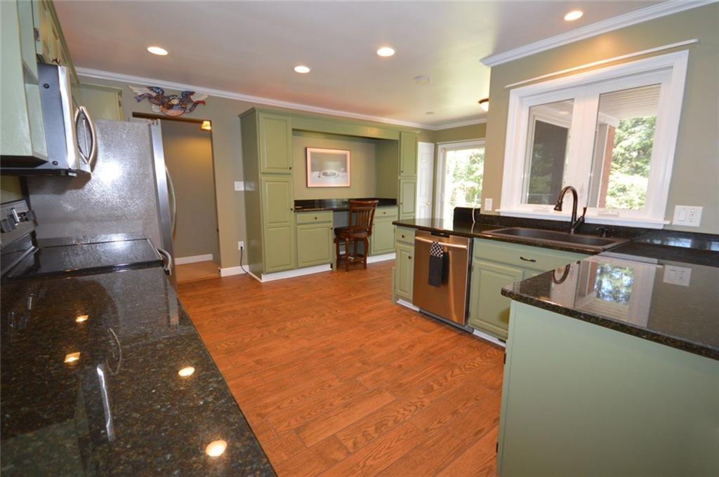 2610 Pulaski Road New Castle, PA 16105 - Photo 7 of 25 Beautiful eat-in kitchen features granite countertops and wood tile floors. Additional kitchen workspace is a great office area.